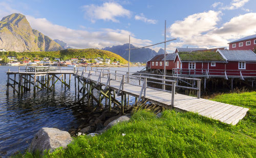 Houses by sea against sky