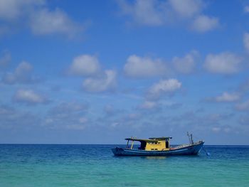 Boat in sea against sky