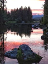 Scenic view of lake against sky at sunset