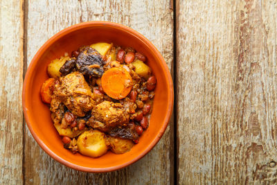 Jewish dish chelnt with meat on a wooden table in a plate. copy space horizontal photo