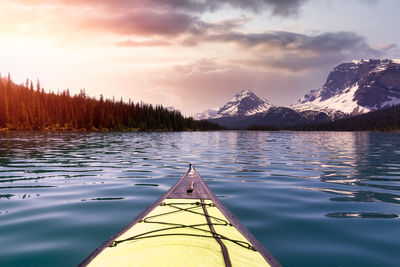 Scenic view of lake by mountains against sky