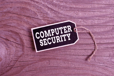 Close-up of information sign on wooden table