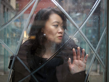 Woman looking through window