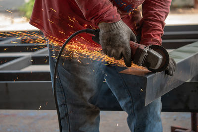 Midsection of welder working on metal