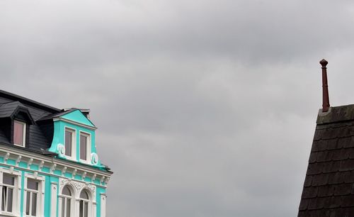 Low angle view of building against cloudy sky