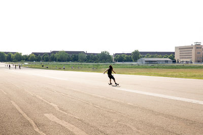 Woman walking on road in city