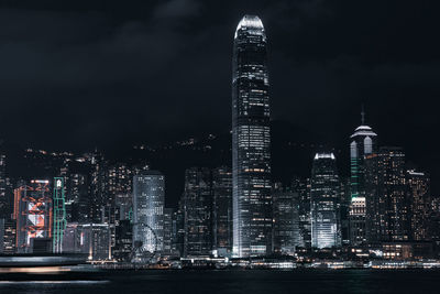 Illuminated buildings in city against sky at night