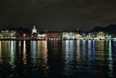 Reflection of illuminated buildings in water at night