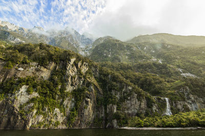 Scenic view of mountains against cloudy sky