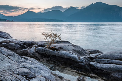 Scenic view of sea and mountains against sky