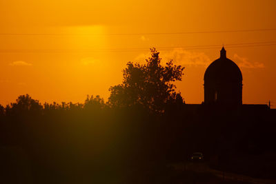 Sunset in summer with silhouette of church dome, italy