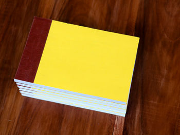 High angle view of yellow paper on table