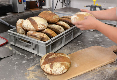 Close-up of hand holding bread on table