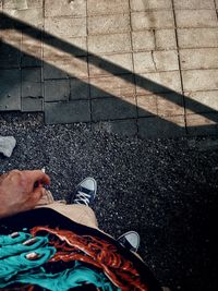 Low section of man standing on street