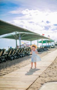 Full length of woman standing against sky