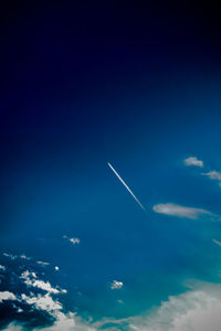 Airplane wing against blue sky