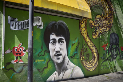 Portrait of man with graffiti on window