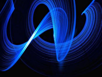 Close-up of light trails over black background
