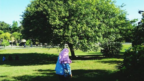 Rear view of woman standing in park