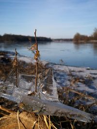 Frozen lake against sky during winter