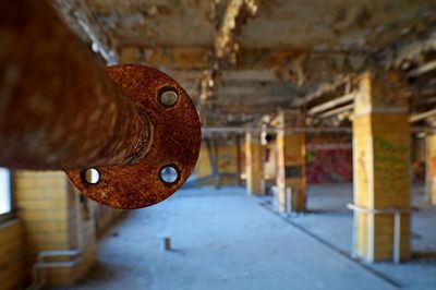 Rusty metallic pipe in basement of abandoned building