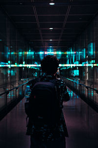 Rear view of woman photographing illuminated car at night