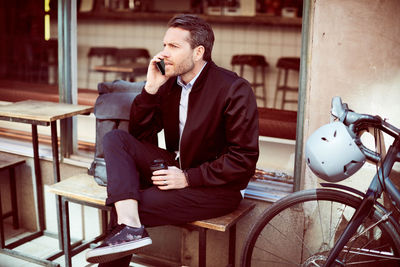 Young man sitting with text