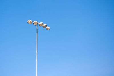 Low angle view of street light against clear blue sky