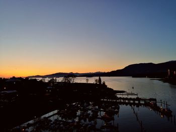 Silhouette of harbor during sunset