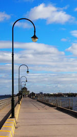 Road by sea against sky