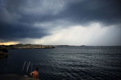 Scenic view of sea against cloudy sky