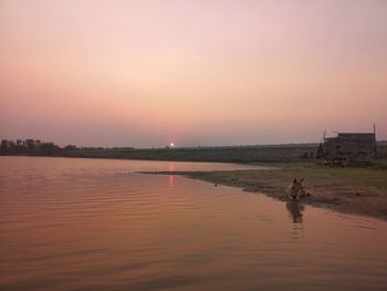 Scenic view of lake against sky during sunset