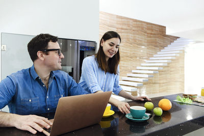 Young woman using laptop at home