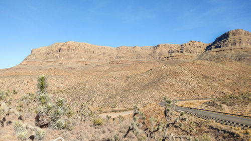 Scenic view of desert against blue sky