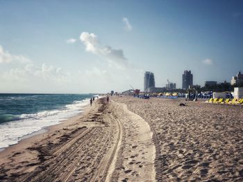 Scenic view of beach against sky in city