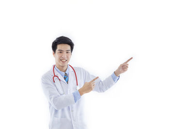 Full length of happy boy standing against white background