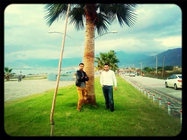 palm tree, sky, tree, transfer print, beach, sea, lifestyles, leisure activity, water, shore, cloud - sky, sand, auto post production filter, cloud, person, grass, men, full length, incidental people