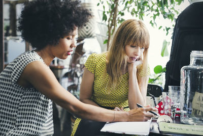 Mid adult female workers discussing in interior design shop