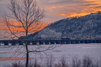 Scenic view of frozen river against sky during sunset