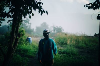 Rear view of man standing on field