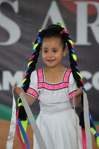 Portrait of smiling girl standing outdoors