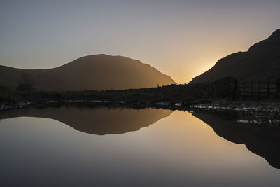 Puddle refection of the mountain iluminated by the sun