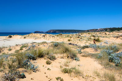 Scenic view of land against clear blue sky