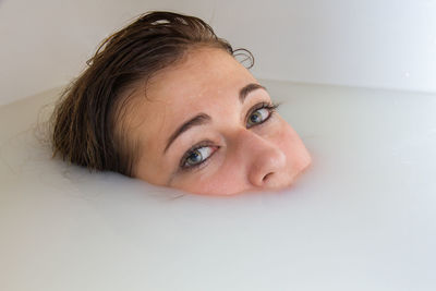 Portrait of woman taking bath in bathtub