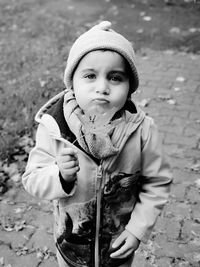 Portrait of cute boy standing in snow