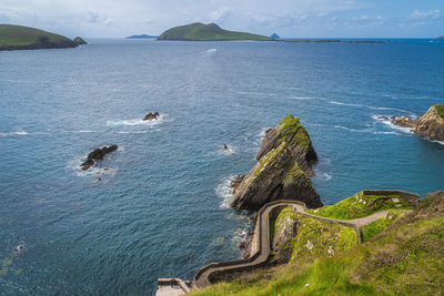 Dunquin pier and harbour with tall cliffs, turquoise water and islands, wild atlantic way, ireland