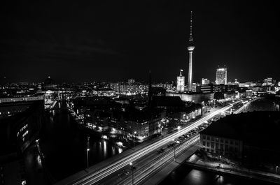 High angle view of city lit up at night