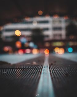 Defocused image of illuminated city street at night