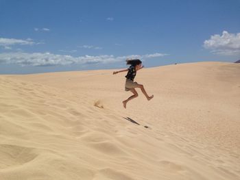 Full length of man on sand at beach against sky