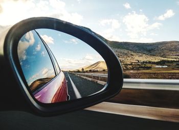 Reflection of sky on side-view mirror